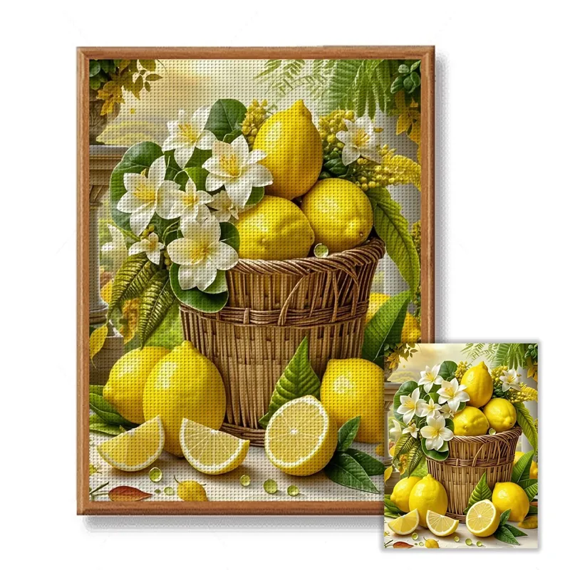 Stamped lemon still-life cross stitch design TM27345: a wicker basket overflowing with lemons and white jasmine, with a halved lemon in front, shown framed