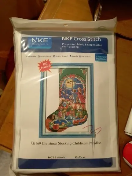 Verified buyer photo of the NKF Christmas stocking kit pouch: HD Printed fabric for the KB169 Children's Paradise design in 16CT, with the size 37 x 53 cm and contents checklist printed on the label